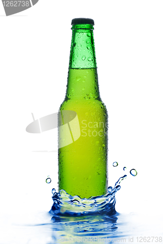 Image of Green beer bottle with water drops and splash isolated on white