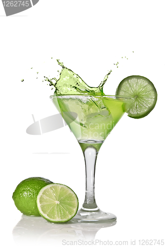 Image of Green alcohol cocktail with splash and green lime isolated on wh