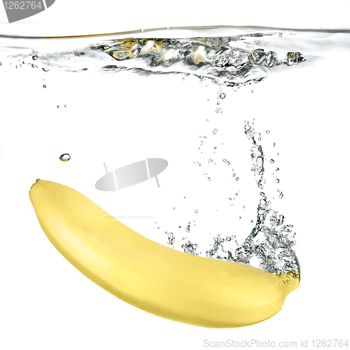Image of banana dropped into water isolated on white