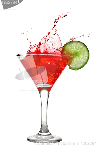 Image of Red cocktail with splash and lime isolated on white