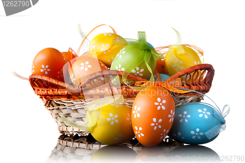 Image of color easter eggs in basket isolated on white