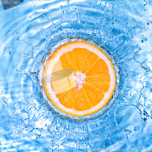 Image of Fresh orange dropped into water with bubbles isolated on white