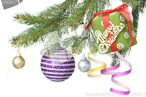 Image of Christmas balls, gift and decoration on fir tree branch isolated