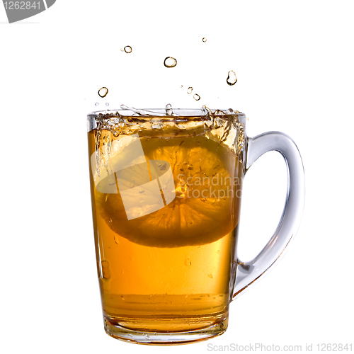 Image of lemon dropped into tea cup with splash and reflection isolated o