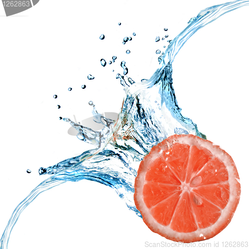 Image of Fresh grapefruit dropped into water with bubbles isolated on whi