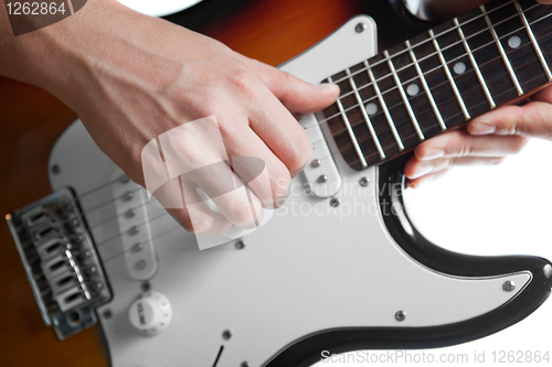 Image of playing on electric guitar