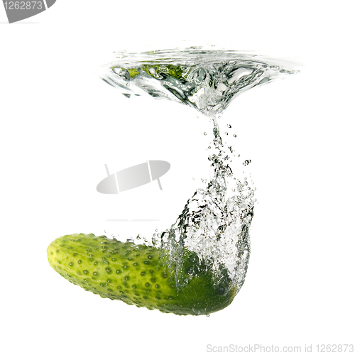 Image of green cucumber dropped into water isolated on white