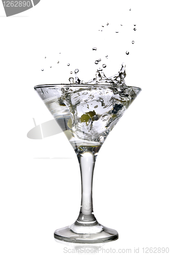 Image of martini with olives and splash isolated on white
