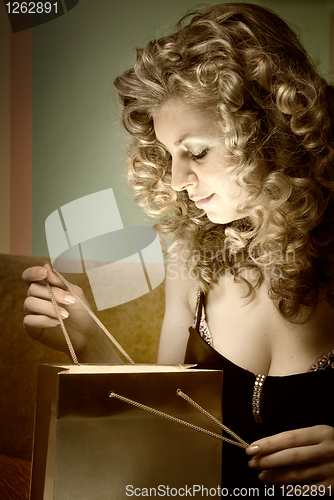 Image of Portrait of attractive happy and smiling woman with gift