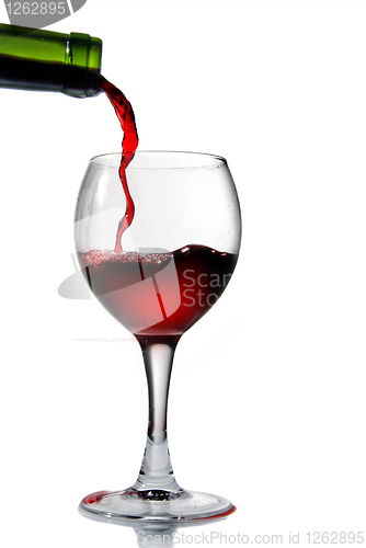 Image of Pouring red wine in goblet isolated on white