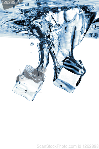 Image of ice cubes dropped into water with splash isolated on white