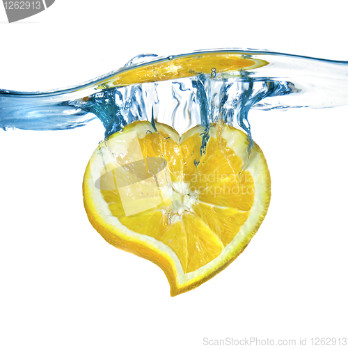 Image of heart from lemon dropped into water isolated on white