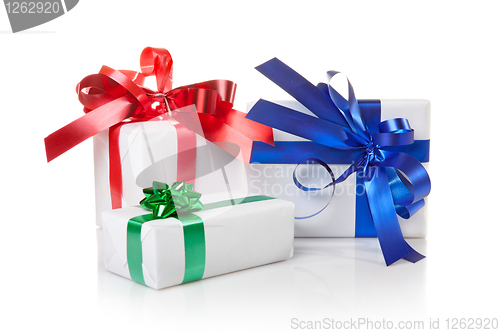 Image of Holiday gifts with color ribbons isolated on white