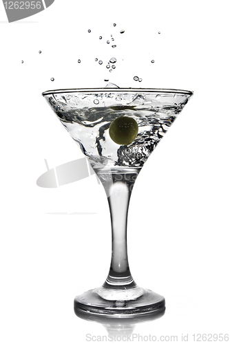 Image of martini with olive and splash isolated on white