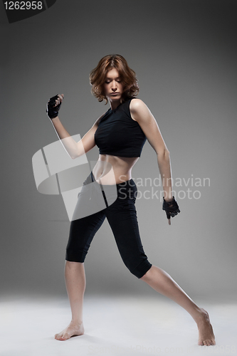 Image of attractive young woman dancing