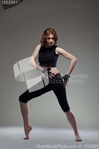 Image of attractive young woman dancing