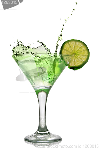 Image of Green alcohol cocktail with splash and green lime isolated on wh