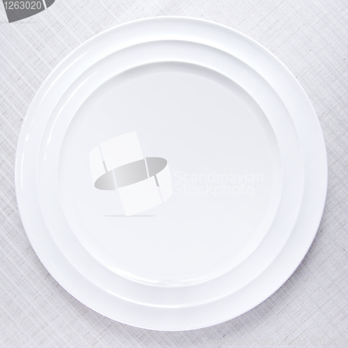 Image of Empty white plate on tablecloth
