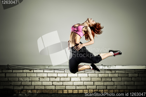 Image of girl jumping on the roof