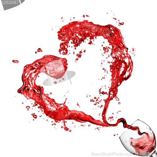 Image of Heart from pouring red wine in glass goblet isolated on white