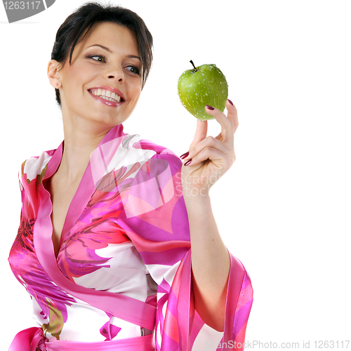 Image of young beautiful happy woman holding green apple on white
