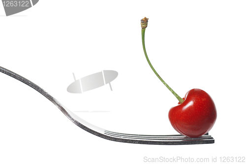 Image of red cherry on fork isolated on white