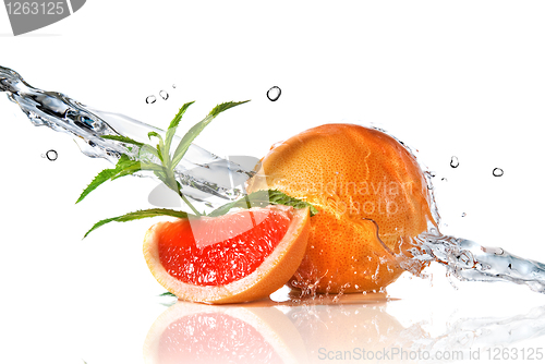 Image of Water splash on grapefruit with mint isolated on white