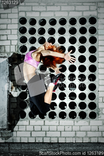 Image of girl jumping on the roof