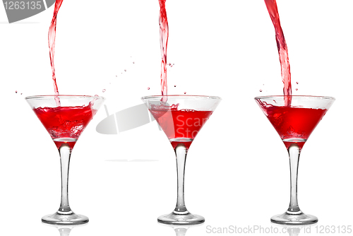Image of Martini cocktail with pouring into glass isolated on white