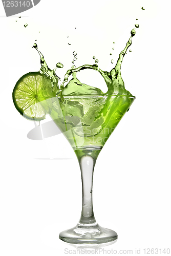 Image of Green alcohol cocktail with splash and green lime isolated on wh