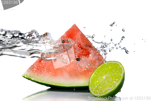 Image of watermelon with lime and water splash isolated on white