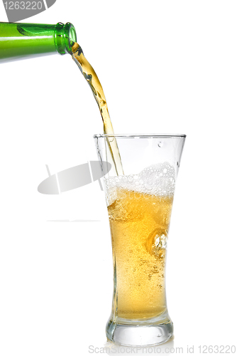 Image of Beer pouring from bottle into glass isolated on white
