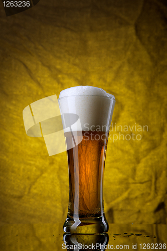 Image of Beer in glass  on yellow background