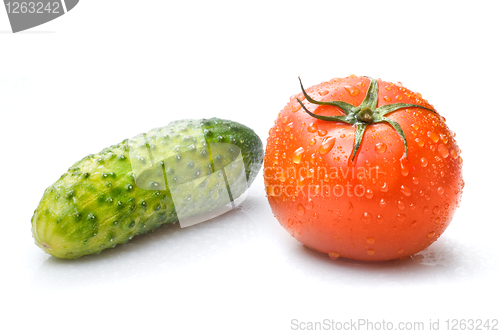 Image of red tomato and green cucumber with water drops isolated on white