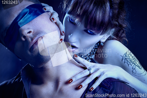 Image of woman vampire bites a blind man