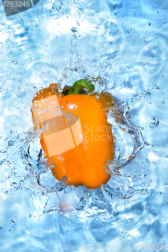 Image of Yellow pepper dropped into water with bubbles isolated on white