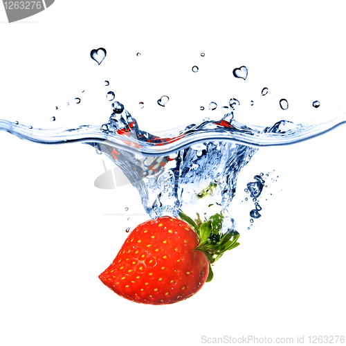 Image of heart from strawberry dropped into water with splash isolated on