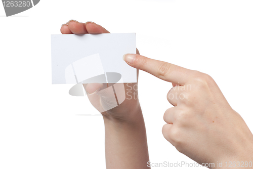 Image of Woman hand holding empty visiting card and pointing on it isolat