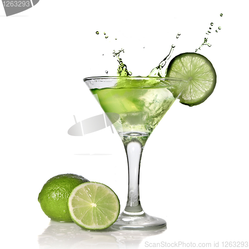 Image of Green alchohol cocktail with splash and green lime isolated on w
