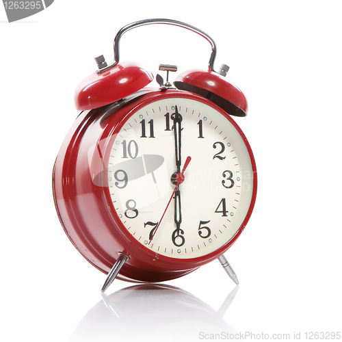 Image of red old style alarm clock isolated on white