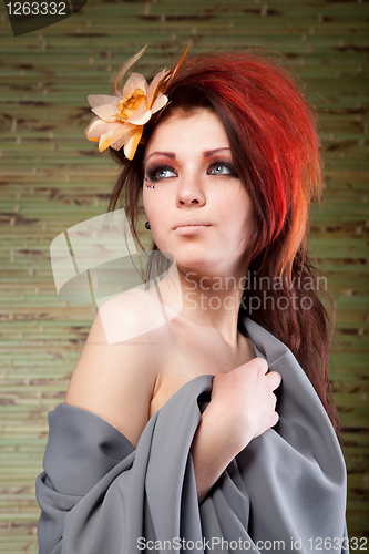 Image of Portrait of beautiful woman with flower in hair