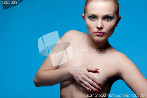 Image of portrait of nude young woman on blue