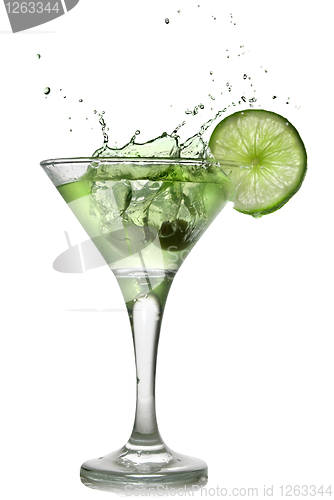 Image of Green alcohol cocktail with splash and green lime isolated on wh