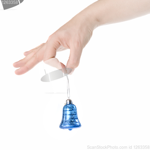 Image of arm holding blue christmas bell isolated on white