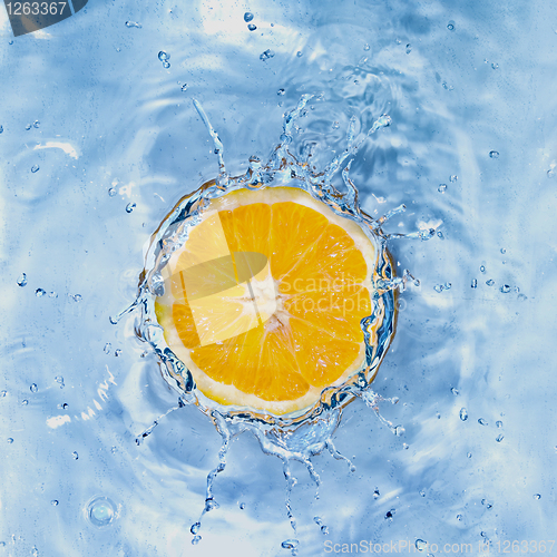 Image of Fresh lemon dropped into water with bubbles isolated on white