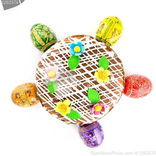 Image of top view of easter eggs and cake isolated on white