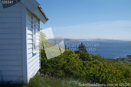 Image of Small, white cabin with seaview