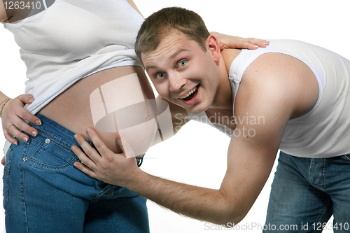 Image of Happy smiling man with pregnant woman isolated on white