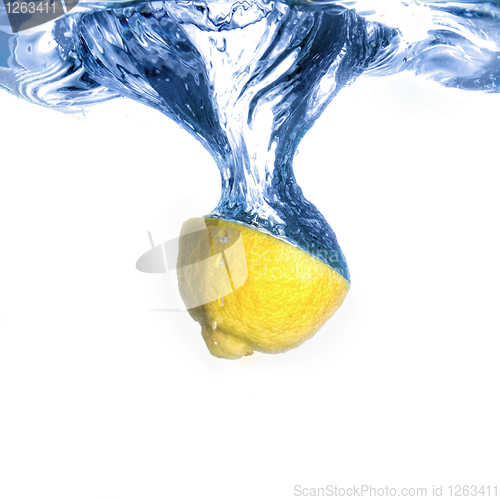 Image of Fresh lemon dropped into water with bubbles isolated on white