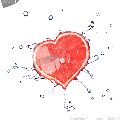 Image of heart from grapefruit dropped into water with splash isolated on